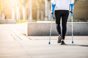 girl with crutches walking alone