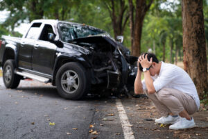 man calling for help after hitting a tree