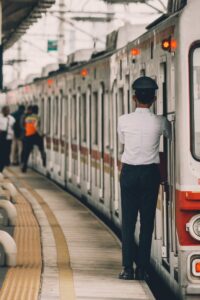 metro train officer standing next to train at station